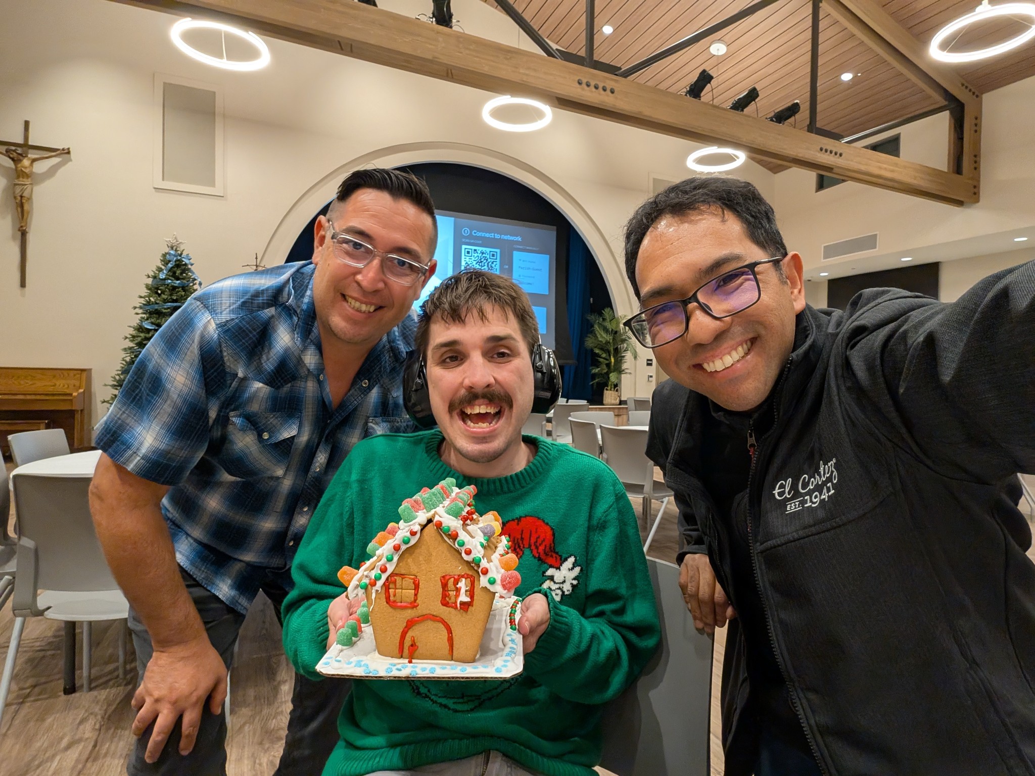Stevenson at Christmas party with gingerbread house